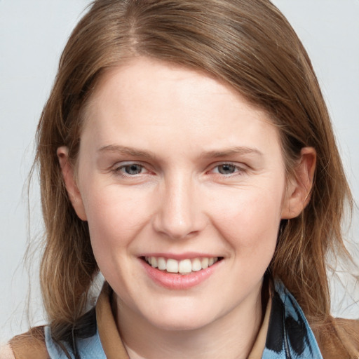 Joyful white young-adult female with medium  brown hair and blue eyes