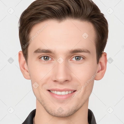 Joyful white young-adult male with short  brown hair and grey eyes