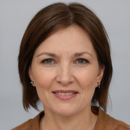 Joyful white adult female with medium  brown hair and brown eyes