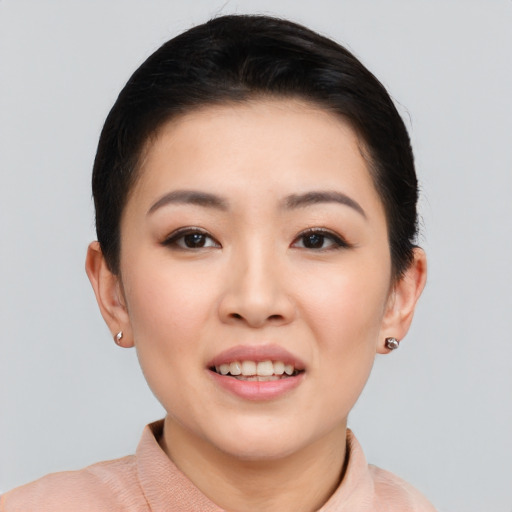 Joyful asian young-adult female with short  black hair and brown eyes