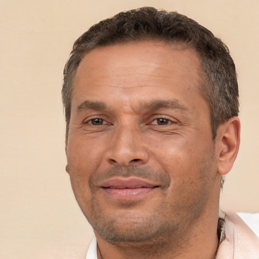 Joyful white adult male with short  brown hair and brown eyes