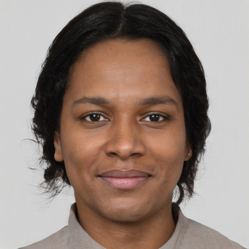 Joyful black young-adult female with medium  black hair and brown eyes