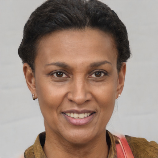 Joyful latino adult female with short  brown hair and brown eyes