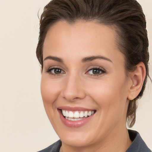 Joyful white young-adult female with medium  brown hair and brown eyes