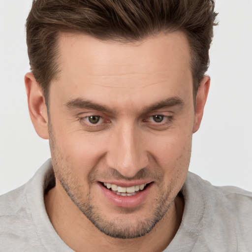 Joyful white adult male with short  brown hair and brown eyes