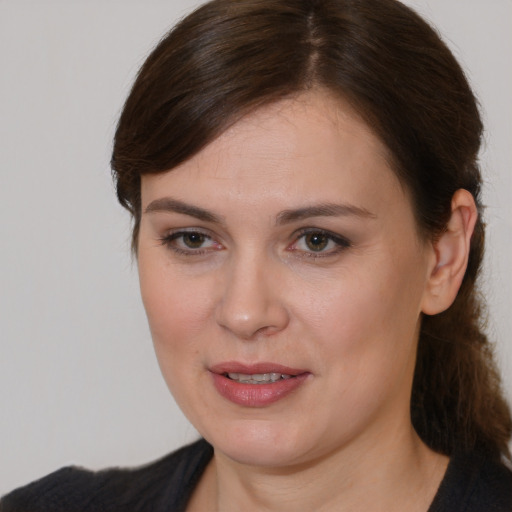 Joyful white young-adult female with medium  brown hair and brown eyes