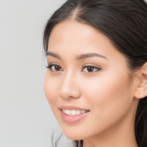 Joyful white young-adult female with long  brown hair and brown eyes