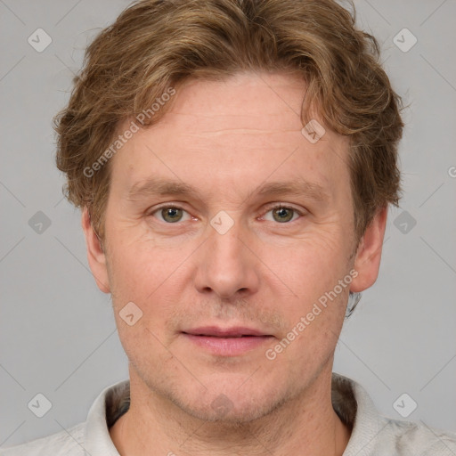 Joyful white adult male with short  brown hair and grey eyes