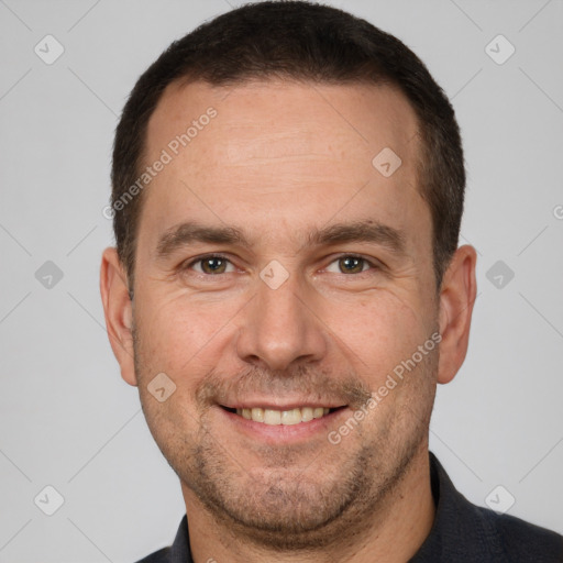 Joyful white adult male with short  brown hair and brown eyes