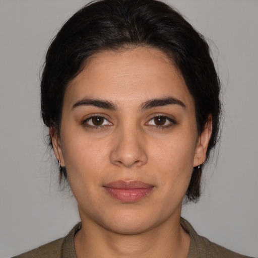 Joyful latino young-adult female with medium  brown hair and brown eyes