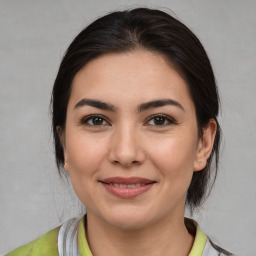 Joyful white young-adult female with medium  brown hair and brown eyes