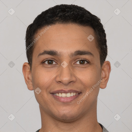 Joyful white young-adult male with short  black hair and brown eyes