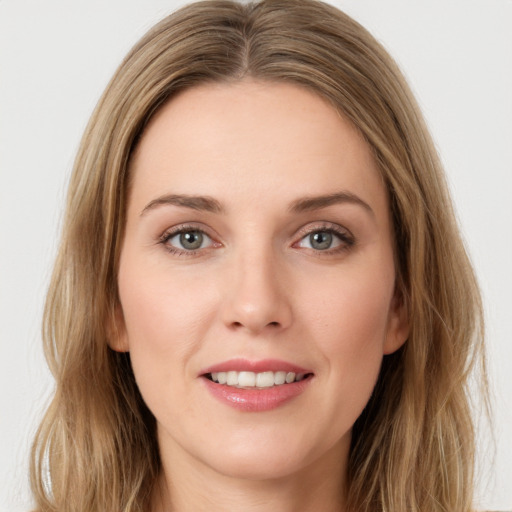 Joyful white young-adult female with long  brown hair and green eyes