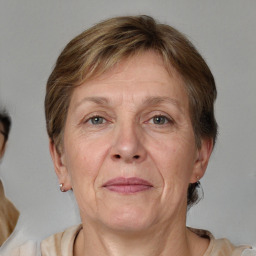 Joyful white middle-aged female with short  brown hair and grey eyes