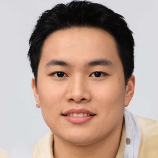 Joyful asian young-adult male with short  black hair and brown eyes