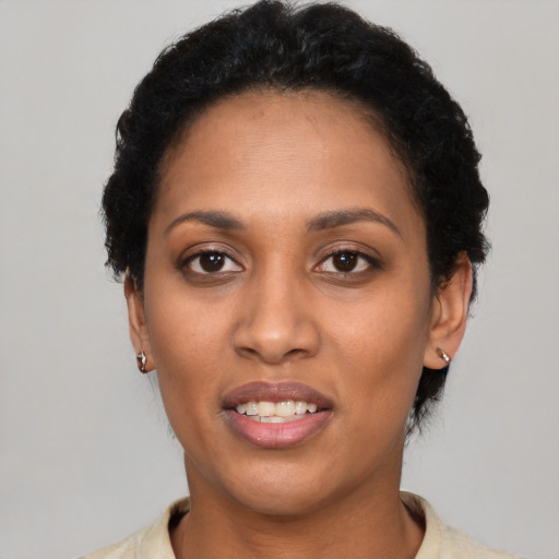 Joyful latino young-adult female with short  black hair and brown eyes