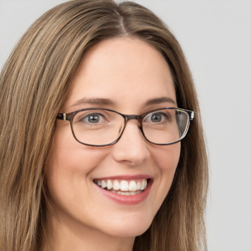 Joyful white young-adult female with long  brown hair and green eyes