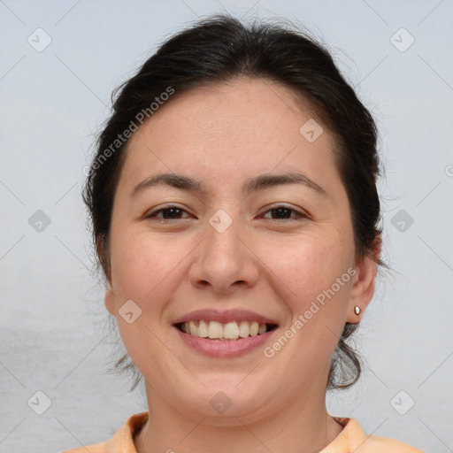 Joyful white adult female with medium  brown hair and brown eyes