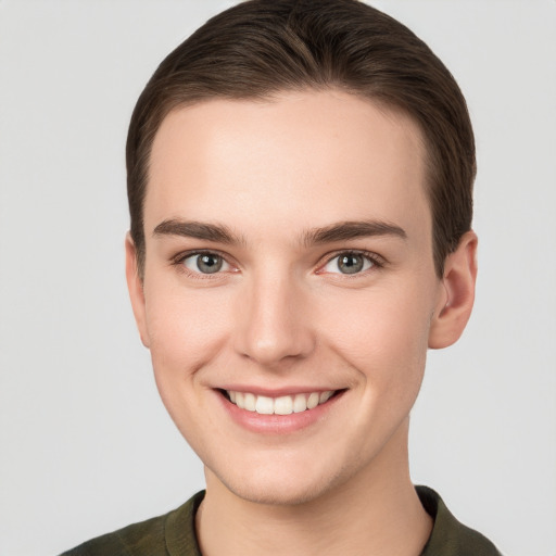 Joyful white young-adult female with short  brown hair and grey eyes