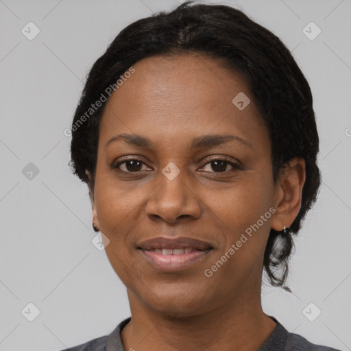 Joyful black adult female with medium  black hair and brown eyes