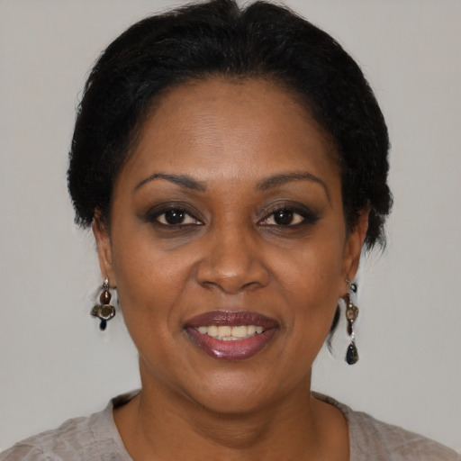 Joyful black adult female with short  brown hair and brown eyes
