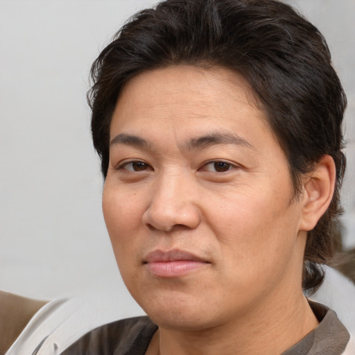 Joyful white adult male with medium  brown hair and brown eyes