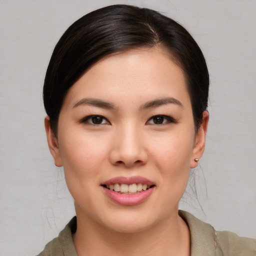 Joyful asian young-adult female with medium  brown hair and brown eyes