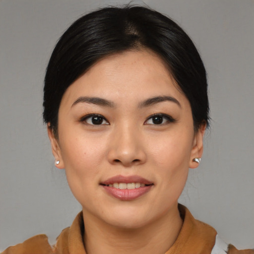 Joyful asian young-adult female with medium  black hair and brown eyes
