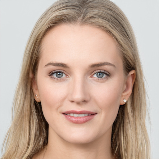 Joyful white young-adult female with long  brown hair and grey eyes