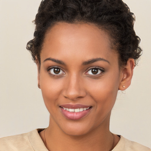 Joyful black young-adult female with short  brown hair and brown eyes