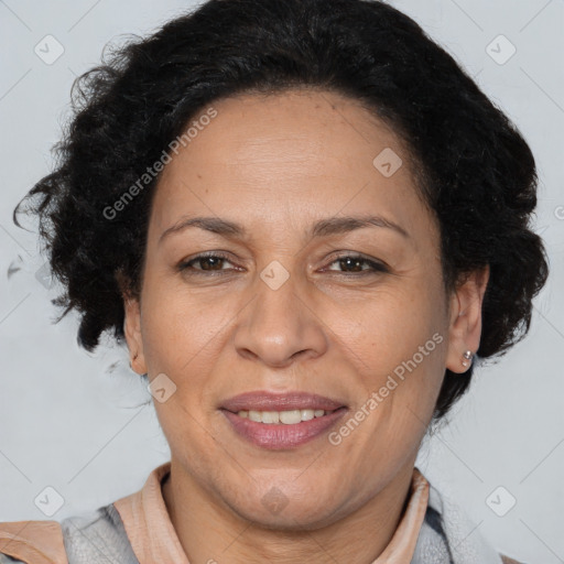 Joyful latino adult female with medium  brown hair and brown eyes