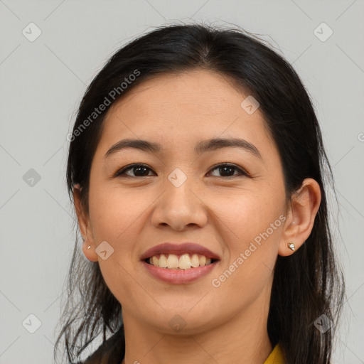 Joyful latino young-adult female with long  brown hair and brown eyes