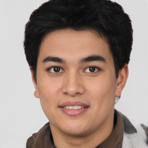 Joyful asian young-adult male with short  brown hair and brown eyes