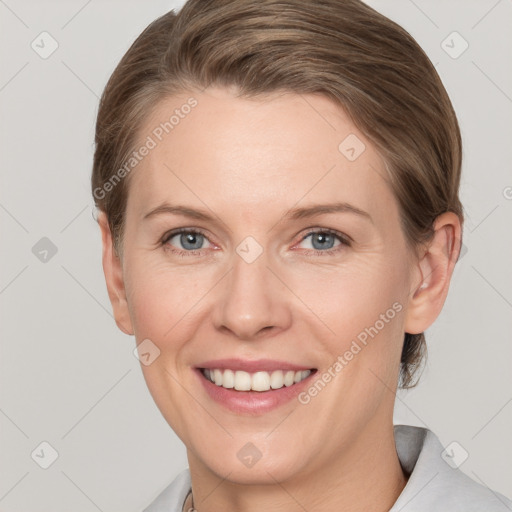 Joyful white young-adult female with short  brown hair and grey eyes