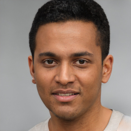 Joyful white young-adult male with short  black hair and brown eyes