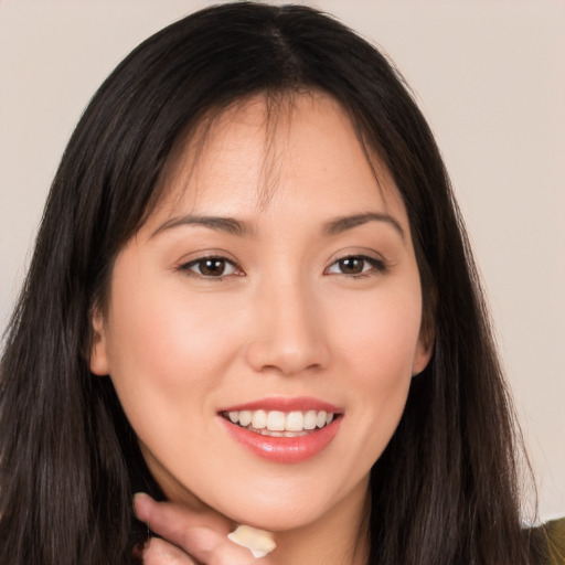 Joyful white young-adult female with long  brown hair and brown eyes