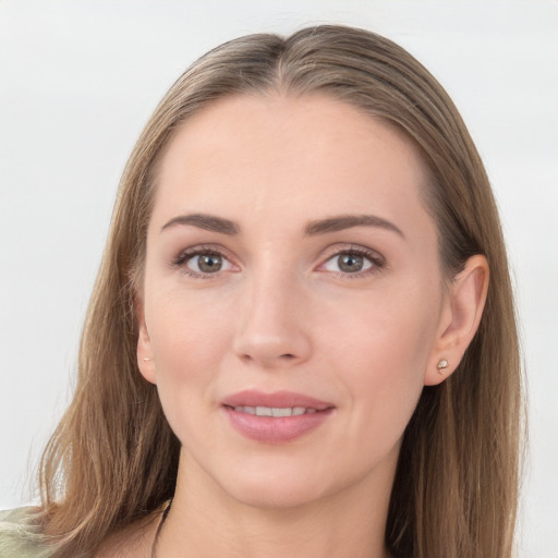 Joyful white young-adult female with long  brown hair and grey eyes