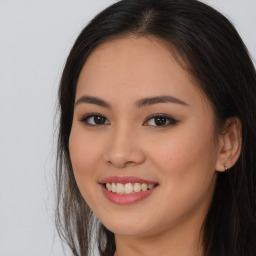 Joyful asian young-adult female with long  brown hair and brown eyes