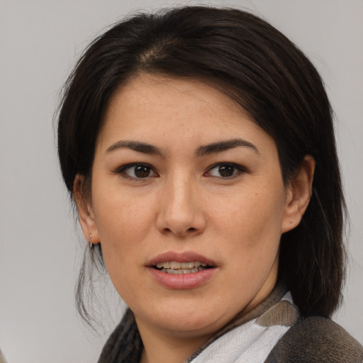 Joyful asian young-adult female with medium  brown hair and brown eyes