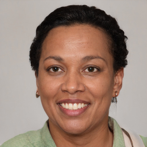 Joyful latino adult female with short  brown hair and brown eyes