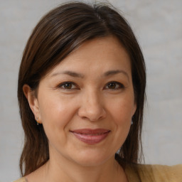 Joyful white adult female with medium  brown hair and brown eyes