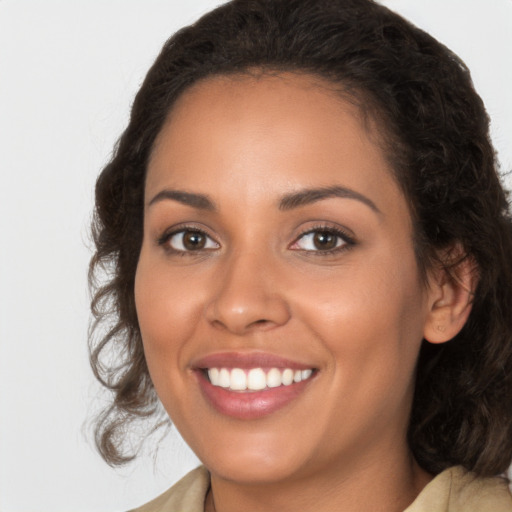 Joyful latino young-adult female with medium  brown hair and brown eyes