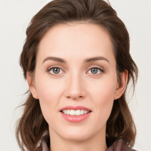 Joyful white young-adult female with medium  brown hair and green eyes