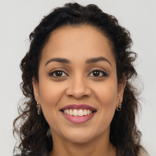 Joyful latino young-adult female with long  brown hair and brown eyes