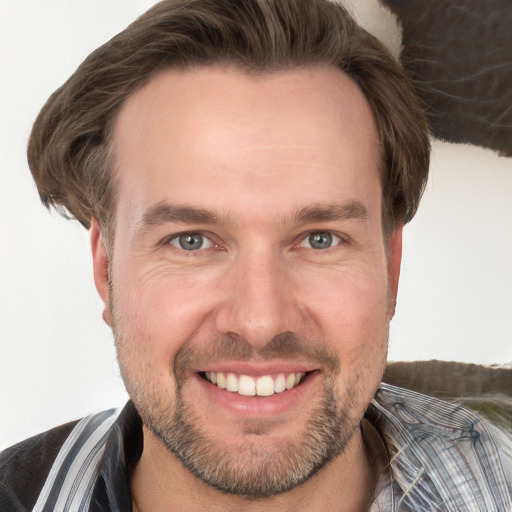 Joyful white adult male with short  brown hair and grey eyes