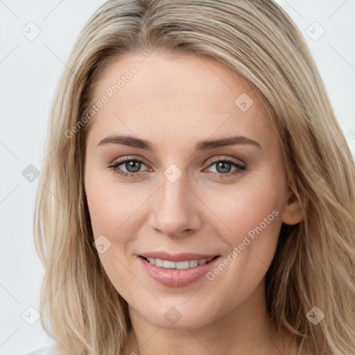 Joyful white young-adult female with long  brown hair and blue eyes