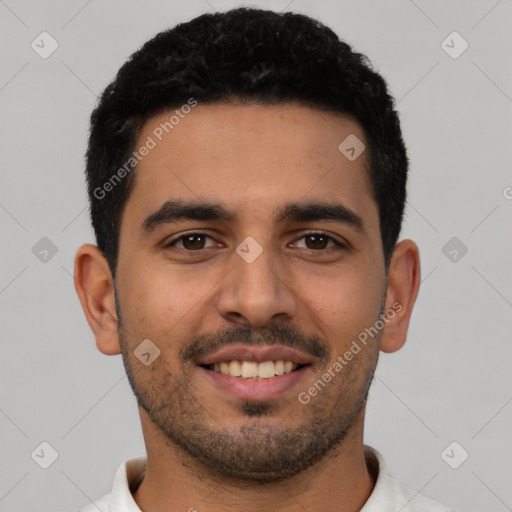 Joyful latino young-adult male with short  black hair and brown eyes