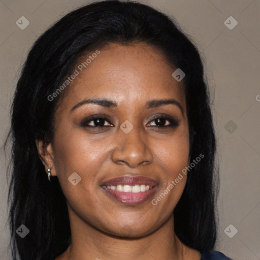 Joyful black young-adult female with long  brown hair and brown eyes