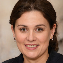 Joyful white adult female with medium  brown hair and brown eyes