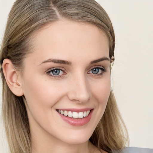 Joyful white young-adult female with long  brown hair and blue eyes